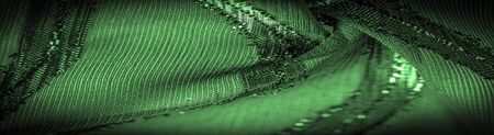 texture  background picture the fabric is transparent emerald green with brightly innate stripes, the material allowing the light to pass through it so that the objects behind are clearly visible.の写真素材