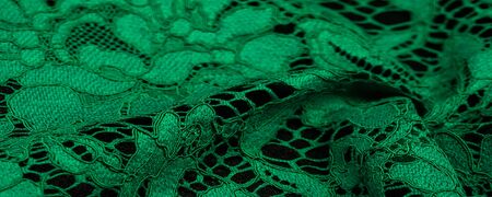 Texture, background, pattern, green lace fabric, Tender embossed lace fabric, scalloped on both edges. Suitable for your projects, design, etc.の写真素材