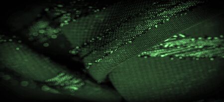 texture  background picture the fabric is transparent emerald green with brightly innate stripes, the material allowing the light to pass through it so that the objects behind are clearly visible.の写真素材