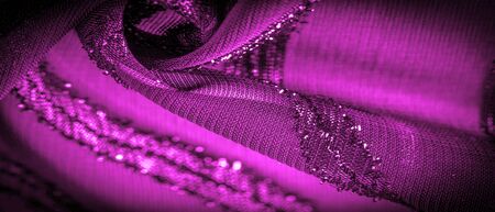 the ornament of the decor, the transparent fabric is purple-red with brightly innate stripes, the material allowing the light to pass through it so that the objects behind are clearly visible.の写真素材