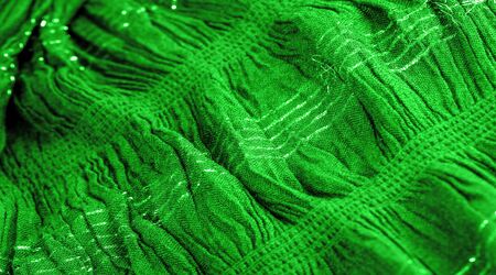 Background texture, ornament decor, emerald green centered corrugated fabric, fabric with parallel or diagonal folds of serrated folds; products from such a fabric.の写真素材
