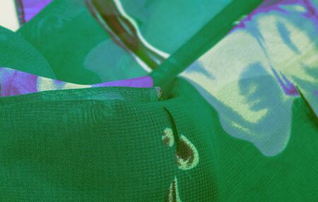 Texture, background, green silk fabric with a blue floral print. Your projects are developed in our studio by designers who have deep knowledge in the use of their final product.の写真素材