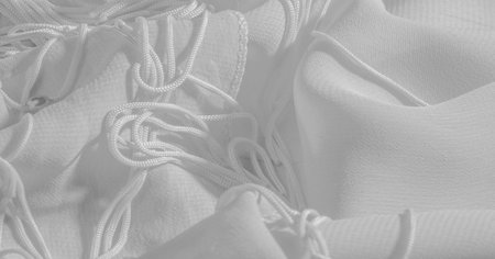 Background, pattern, texture, wallpaper, white silk fabric has a brilliant shine. This is the most...
