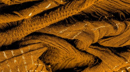 The texture of the background pattern, ornament decor, golden yellow corrugated fabric, fabric with parallel or diagonal folds of serrated folds; products from such a fabric.の写真素材