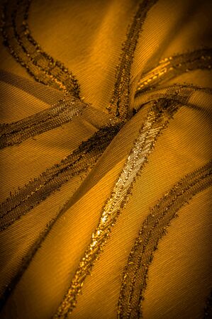 ornament of the decor, the fabric is transparent mustard yellow with brightly congenital stripes, the material allowing the light to pass through it so that the objects behind are clearly visibleの写真素材