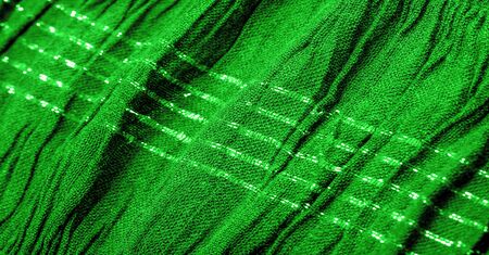 Background texture, ornament decor, emerald green centered corrugated fabric, fabric with parallel or diagonal folds of serrated folds; products from such a fabric.の写真素材