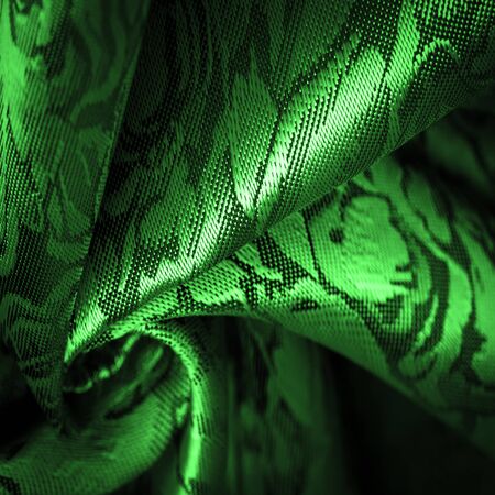 relief pattern, composite textiles, green silk fabric with a floral pattern, unusually pleasant visual sensations: slippery, coolness, softness; beautiful appearance, unique luster;の写真素材