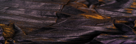 texture. background. template. wallpaper. black silk fabric with yellow golden stripes, wrinkled...