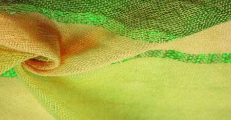 Background texture pattern, ornament, background, silk fabric, large strips of yellow green, separated by a strip of emerald gold, this fabric will decorate your design, you will be the bestの写真素材