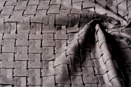 Textured, background, pattern, Woven fabric of intertwined folded strips of gray. Fashionable interior design, web pages, and other.の写真素材