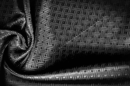 Background texture, pattern. Black silk fabric with a small checkered pattern. You do not need smoke and mirrors, this Katia smoky gray checkered SILK yarn speaks for itself. creates airy fabricの写真素材