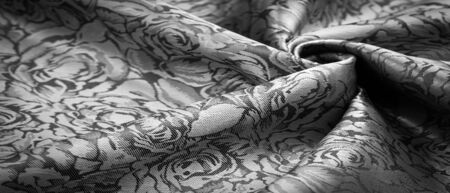 relief pattern, composite textile, silk fabric in black and white, with a floral pattern, unusually pleasant visual sensations: slippery, coolness, softness; beautiful appearance, unique shineの写真素材
