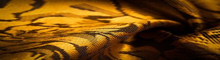 embossed pattern, composite textile, silk fabric of yellow, gold color, with a floral pattern, unusually pleasant visual sensations: slippery, coolness, softness; beautiful appearance, unique shine;の写真素材