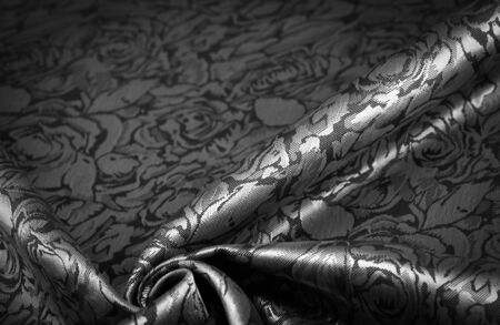 relief pattern, composite textile, silk fabric in black and white, with a floral pattern, unusually pleasant visual sensations: slippery, coolness, softness; beautiful appearance, unique shineの写真素材