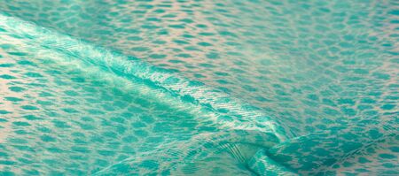 The texture, background, pattern, green white silk fabric is textile. Its properties differ from woven material in that it is more flexible and simple in design.の写真素材