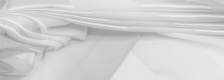 Texture, background, white silk striped fabric with a metallic sheen. If you have a bad mood, this fabric will lift it to unprecedented heights. Your project will be successful.の写真素材