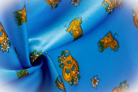 Texture, background, pattern, blue silk with a shoe print in the form of a flowerpot, Organza is a thin, smooth, transparent fabric traditionally made of silk.の写真素材