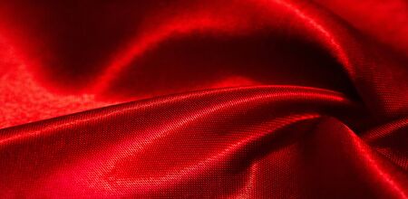 texture, background, pattern, silk fabric of red color. This adorable, soft and shiny fabric has a smooth mink surface ideal for creating your projects.の写真素材
