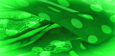 Background texture, decorative ornament, green polka dot fabric, round dots on fabric that have the...