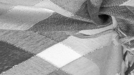Texture, background, silk scarf feminine black and white with a metal stripe. The scarf is decorated...