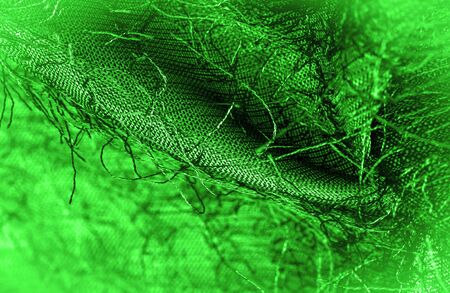 Background texture, decorative ornament, green silk fabric, woven threads on the fabric, fluffy effect, feeling, appearance or texture of the surfaceの写真素材