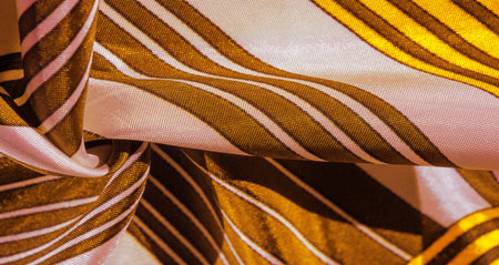 Texture, background, silk fabric with a yellow striped pattern. The design of this fabric is...