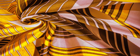 Texture, background, silk fabric with a yellow striped pattern. The design of this fabric is...