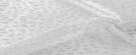 The texture, background, pattern, white silk fabric is textile. Its properties differ from woven material in that it is more flexible and easier to design.の写真素材
