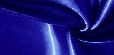 Texture, background, pattern, silk fabric in blue. This adorable, soft and shiny fabric has a smooth mink surface, perfect for creating your projects.の写真素材