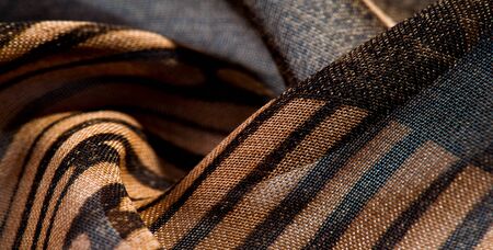 texture, background, pattern, wallpaper. brown silk fabric pattern. This medium-weight rayon fabric has a nice shine with slight color variations. Perfect for adding elegance to your designs.の写真素材
