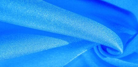 Texture, background, pattern, silk fabric in blue. This silk is incredibly exquisite. Projects made from this will last a long time and will still be in fairly good condition.の写真素材