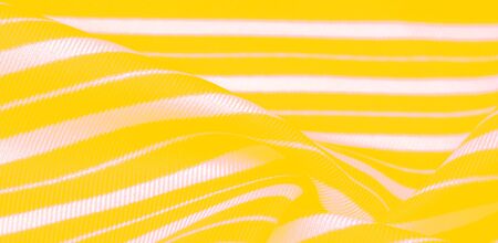 silk striped fabric. yellow white stripes. This beautiful, super soft, medium-sized silk blend is perfect for your design projects. It is brushed on the back for a luxurious feeling.の写真素材