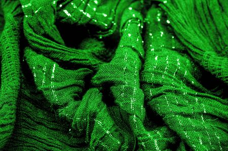 Background texture, ornament decor, emerald green centered corrugated fabric, fabric with parallel or diagonal folds of serrated folds; products from such a fabric.の写真素材