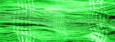 Background texture, ornament decor, emerald green centered corrugated fabric, fabric with parallel or diagonal folds of serrated folds; products from such a fabric.の写真素材