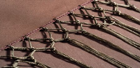 Background texture of silk fabric. This is a natural brown scarf, this beautiful nylon satin made of...