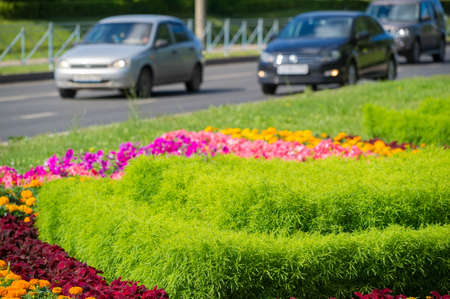 City photo, Flowerbeds in the city, in the background motorway with cars, Russia Naberezhnye Chelny 18,08,2018gのeditorial素材