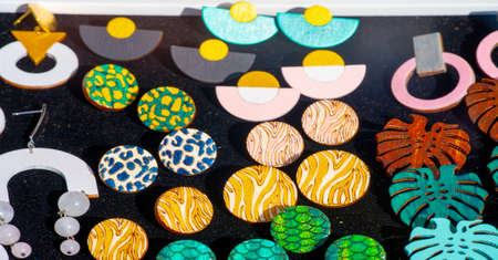 Texture, background, pattern. Folk art. Women's earrings are a piece of jewelry that is worn on the earlobe or edge of the ear. shackle, eardrop, link, connecting link, hangerの写真素材