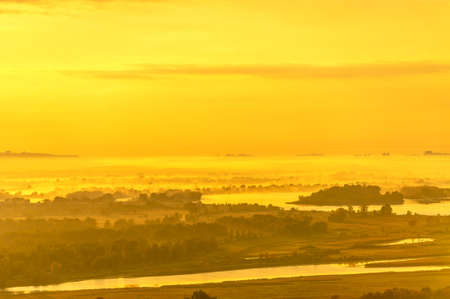 Summer landscape of the river. Sunrise sunset. every day on planet Earth can begin serene with the rising of the sun, when the sky gently brightens over the golden eastern horizon.の写真素材