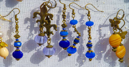 Texture, background, pattern. Folk art. Women's earrings are a piece of jewelry that is worn on the earlobe or edge of the ear. shackle, eardrop, link, connecting link, hangerの写真素材