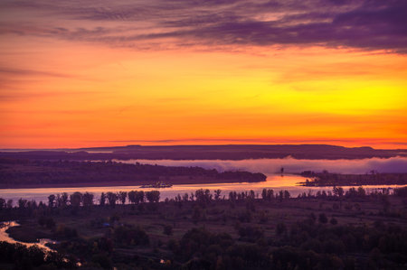 Summer landscape of the river. Sunrise sunset. A constant flow of water of considerable size with a...