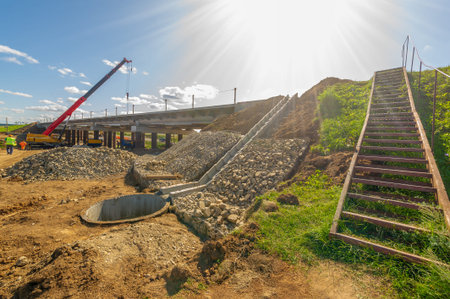 Photograph of engineering structures. Construction of a road bridge over a river