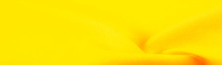 Texture, background, design, yellow gold fabric, twill. Thin fabric with diagonal weaving of threads. From Latin and French, the name of the material is translated as âsilkâ.の写真素材