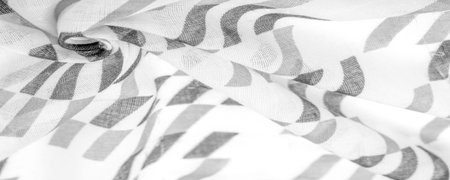 White silk fabric with black geometric rhombus shapes. dark. Background. Template.