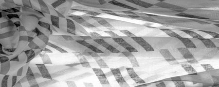 White silk fabric with black geometric rhombus shapes. dark. Background. Template.の写真素材