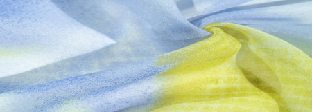 silk fabric in soft blue, yellow and white tones with abstract patterns and bed tones. Texture,...