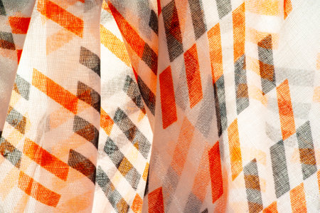 White silk fabric with red and black geometric rhombus shapes. abstract illustration pink-orange franc, close-up, background for design, vintage bright pattern. Texture. Background. Template.の写真素材