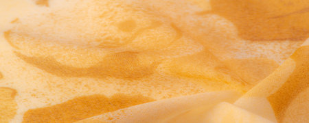 Texture. background. template. Abstract yellow silk chiffon fabric. Milk-colored taffeta silk fabric artistic layout.の写真素材