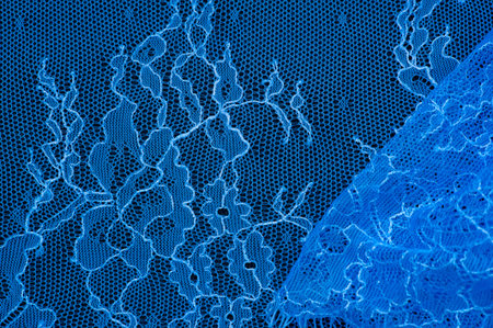 Blue lace on a black background. Template for wedding invitation and greeting card with lace fabric...