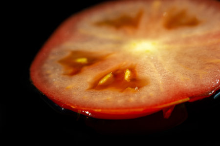 Berry food. Sliced love apple. The tomato is an edible, often red, berry of the plant Solanum lycopersicum, commonly known as the tomato plant. The species occurred in western South America.の写真素材