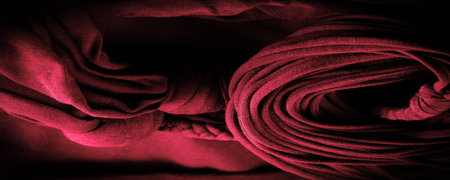 Texture, background, pattern. Fabric in red braids. Knitted knitted background with embossed pattern. Braids in knitting.の写真素材